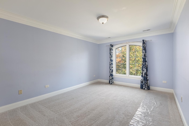 unfurnished room with baseboards, visible vents, ornamental molding, and light colored carpet