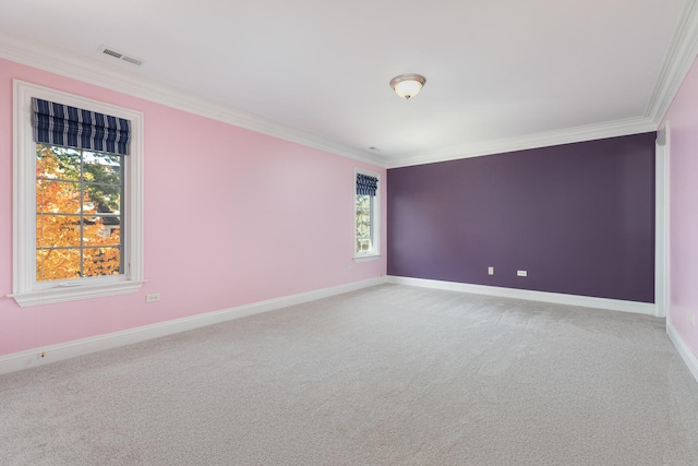 unfurnished room with ornamental molding, carpet flooring, visible vents, and baseboards