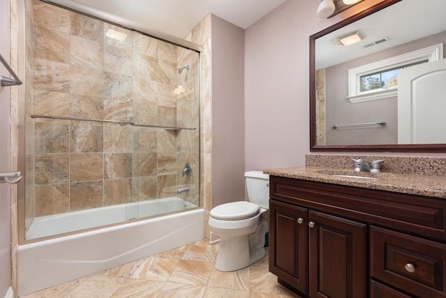 bathroom with visible vents, shower / bath combination with glass door, vanity, and toilet