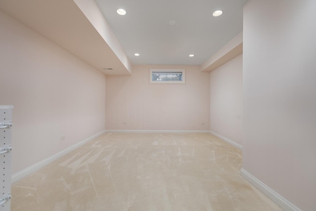 empty room featuring recessed lighting, light colored carpet, and baseboards