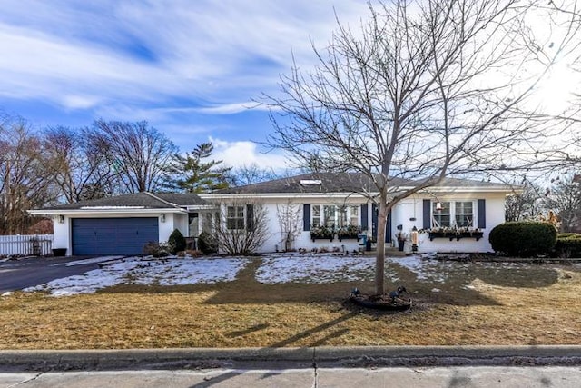 single story home with driveway and a garage