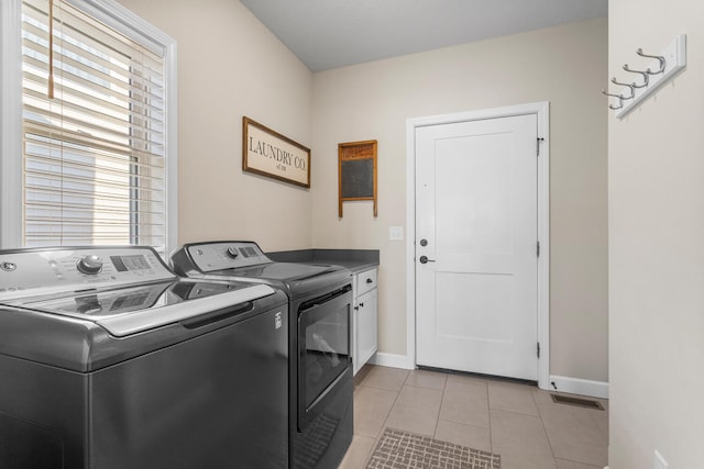 laundry room with cabinet space, visible vents, baseboards, independent washer and dryer, and light tile patterned flooring