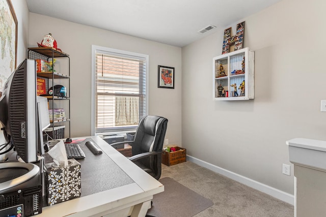 office featuring carpet flooring, visible vents, and baseboards