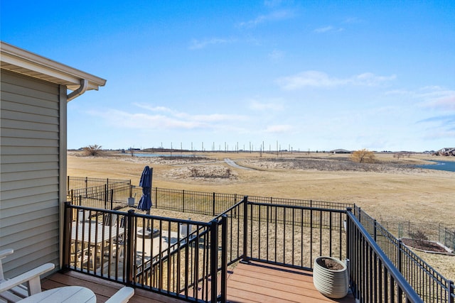 wooden terrace featuring a rural view, cooling unit, and fence