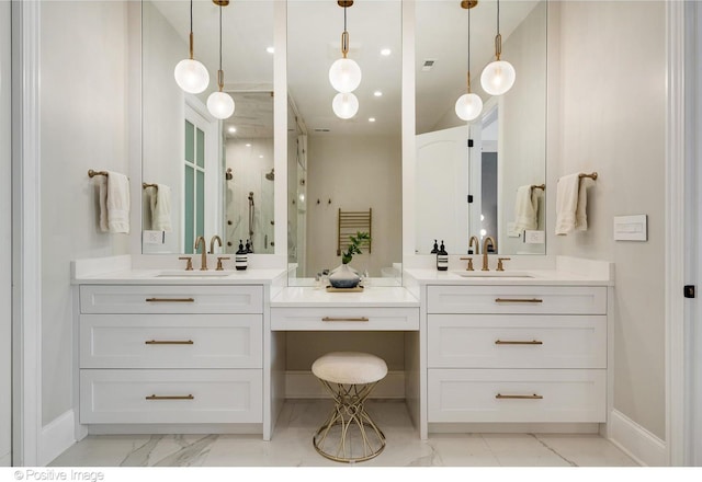 full bath featuring marble finish floor, a sink, a stall shower, and two vanities