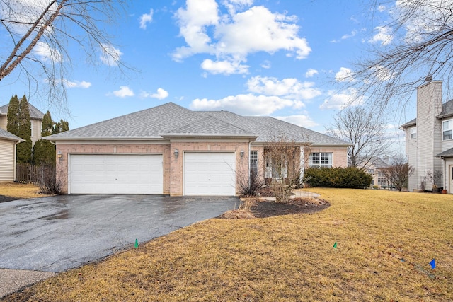 ranch-style home with brick siding, roof with shingles, an attached garage, driveway, and a front lawn