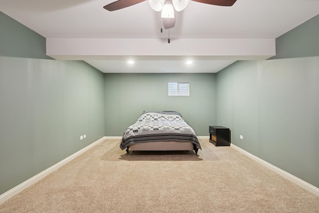 carpeted bedroom featuring ceiling fan and baseboards