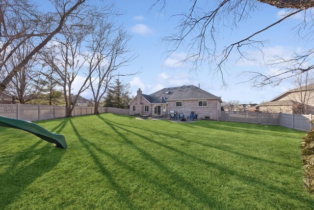 view of yard with a patio area and a fenced backyard