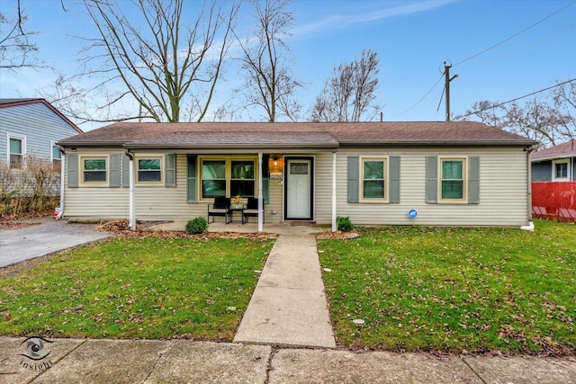 ranch-style house with a porch and a front lawn