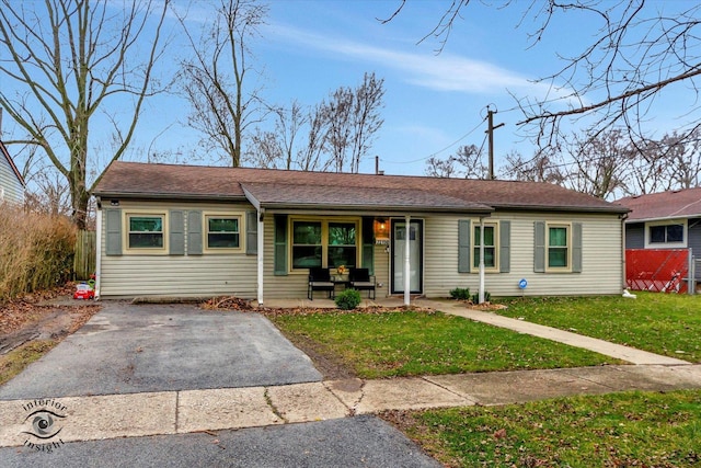 ranch-style home featuring driveway, a porch, and a front yard