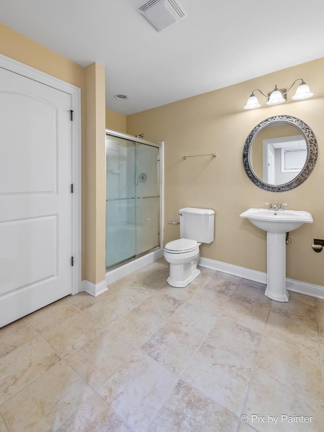 bathroom featuring a stall shower, visible vents, toilet, and baseboards