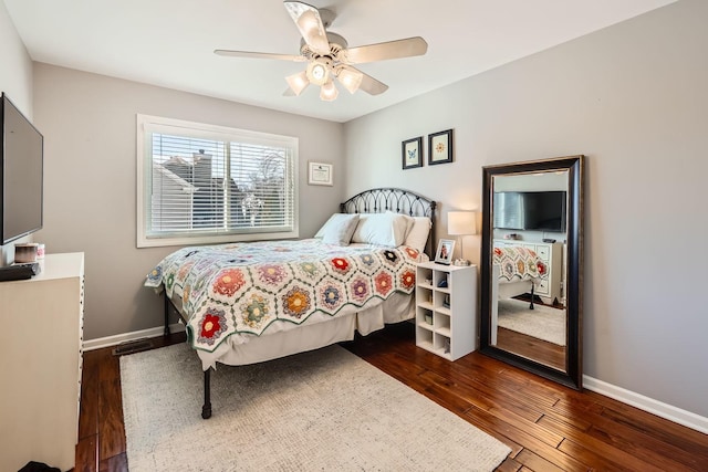 bedroom with dark wood-style floors, ceiling fan, and baseboards