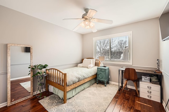 bedroom with dark wood-style floors, baseboards, and a ceiling fan