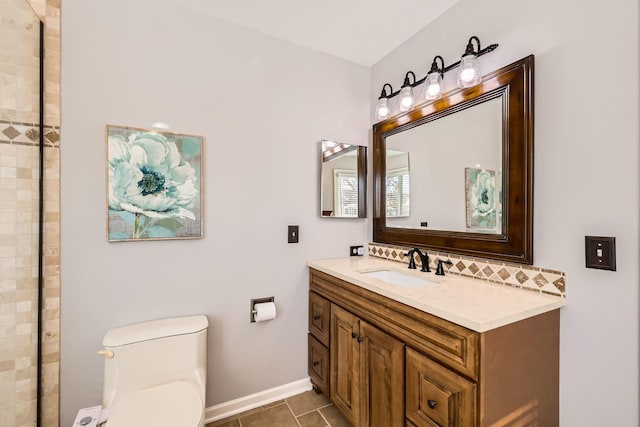 full bathroom featuring toilet, tile patterned flooring, baseboards, and vanity