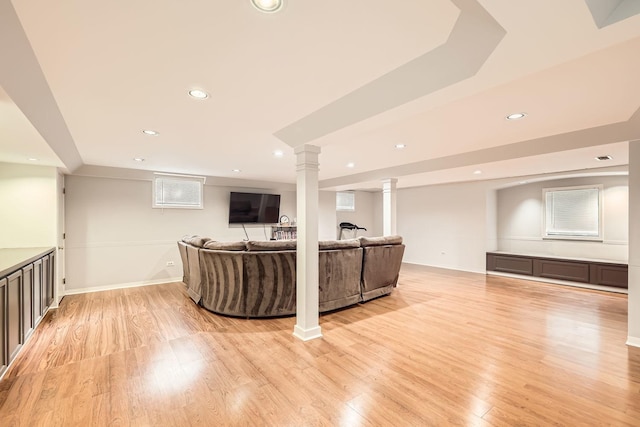 living room featuring light wood-type flooring, ornate columns, baseboards, and recessed lighting