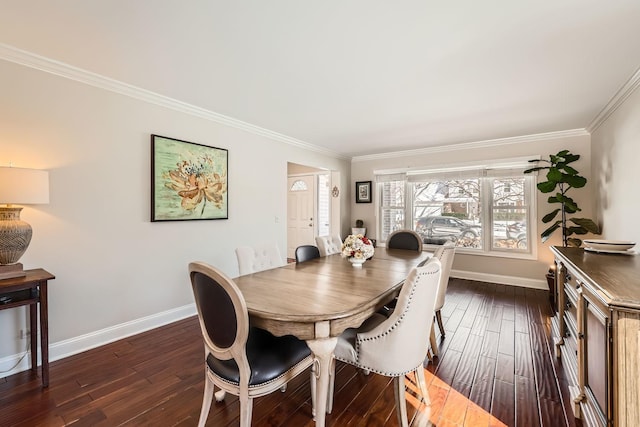 dining area featuring baseboards, ornamental molding, and dark wood finished floors