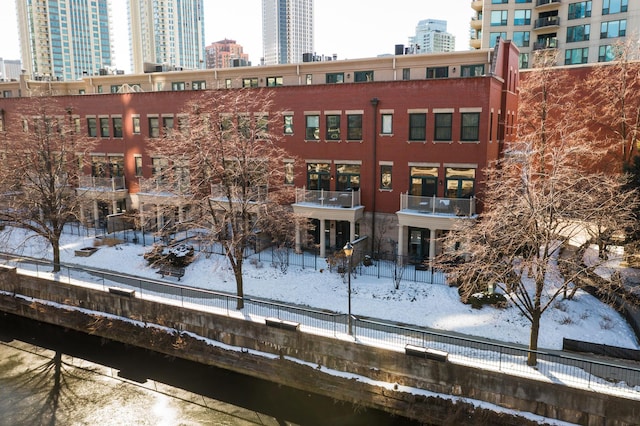 snow covered property with a view of city