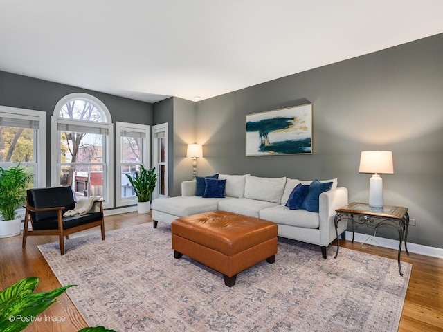 living area with wood finished floors and baseboards