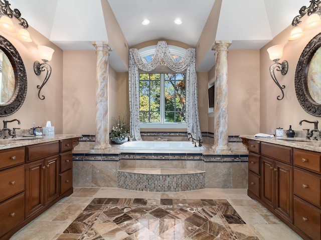 bathroom featuring a sink, ornate columns, and a bath