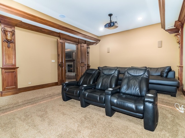 home theater featuring recessed lighting, a fireplace, baseboards, and light colored carpet