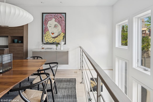 dining area with light wood-type flooring and recessed lighting