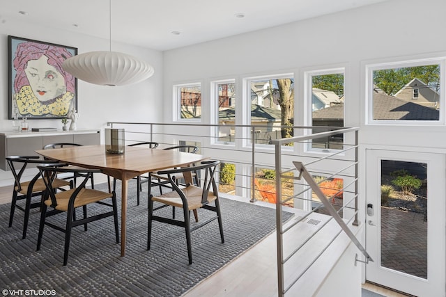 dining area featuring wood finished floors and recessed lighting