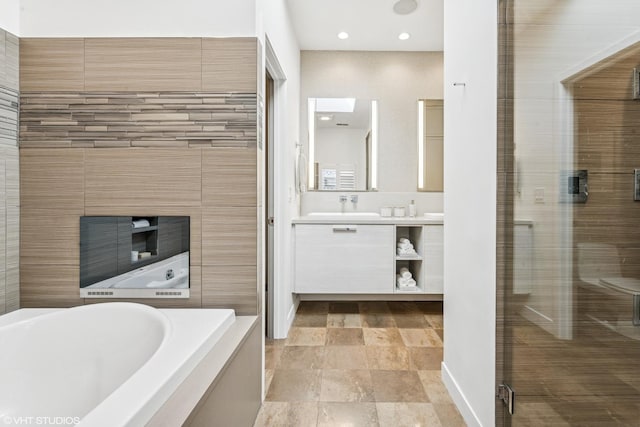 full bath featuring a stall shower, vanity, a bath, and recessed lighting