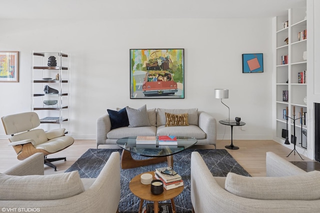 living area featuring baseboards and wood finished floors