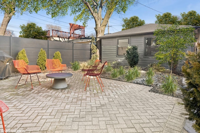 view of patio / terrace with grilling area and fence