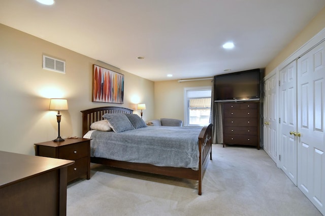 bedroom featuring light carpet, visible vents, and recessed lighting