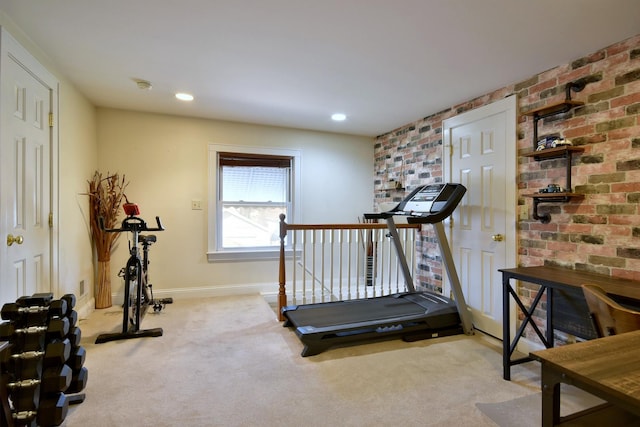 workout area featuring brick wall, baseboards, carpet flooring, and recessed lighting