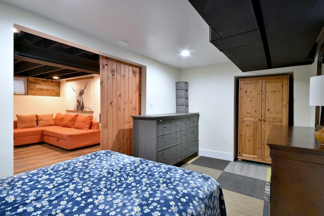 bedroom with wood finished floors and baseboards