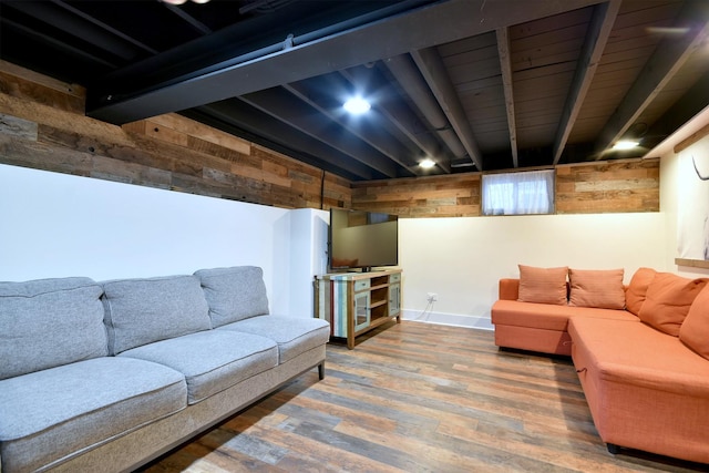 living room featuring wood finished floors, beam ceiling, and baseboards