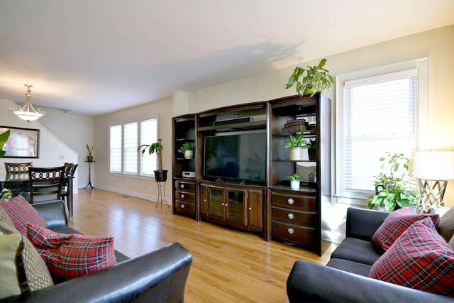 living area with wood finished floors and baseboards