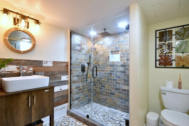 bathroom featuring a stall shower, vanity, and toilet