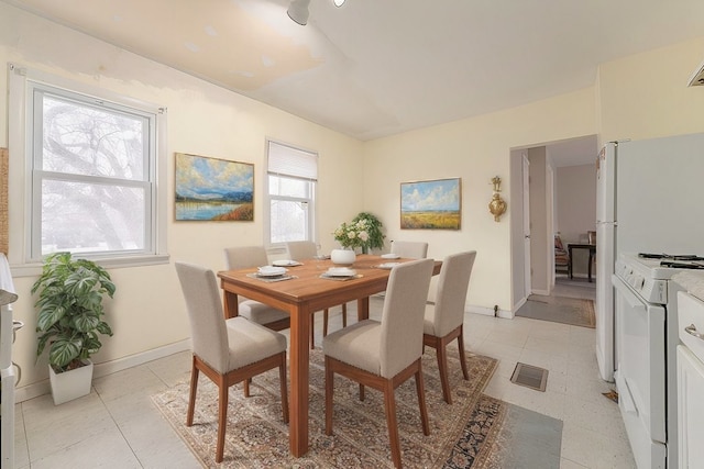 dining room featuring visible vents and baseboards