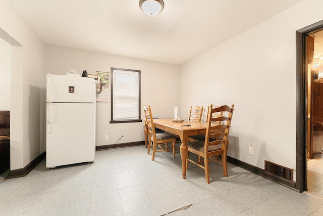 dining area featuring light floors, baseboards, and visible vents