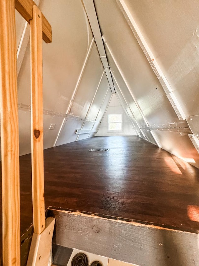 bonus room featuring vaulted ceiling and wood finished floors