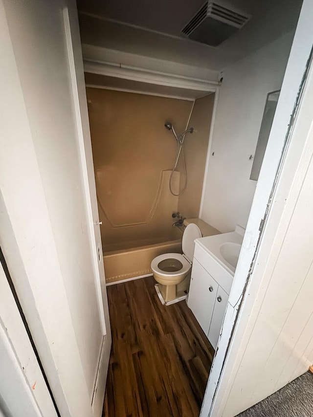 full bath featuring toilet, shower / bath combination, wood finished floors, vanity, and visible vents