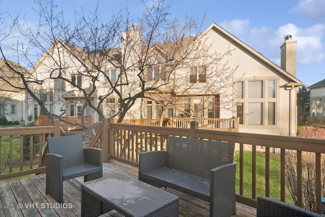 wooden deck with an outdoor living space