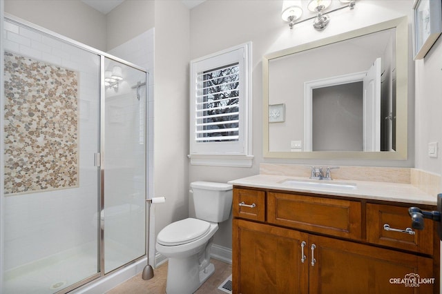 full bathroom with vanity, toilet, and a stall shower