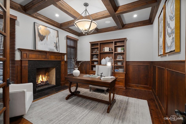 home office with a wainscoted wall, beamed ceiling, a fireplace, and dark wood-style flooring