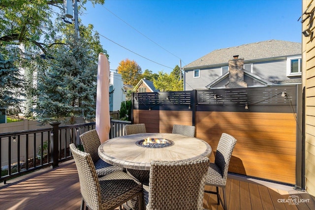 wooden terrace featuring outdoor dining area