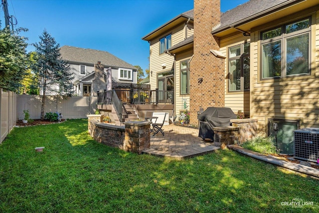 view of yard featuring a deck, cooling unit, a patio, and a fenced backyard