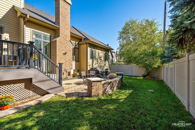 view of yard with an outdoor fire pit, a fenced backyard, and a patio area