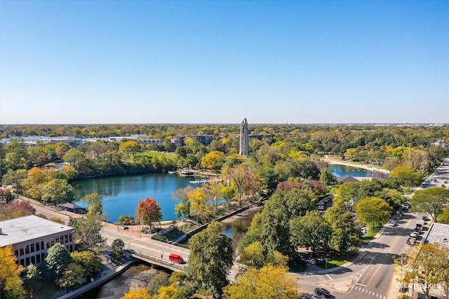 birds eye view of property with a forest view and a water view