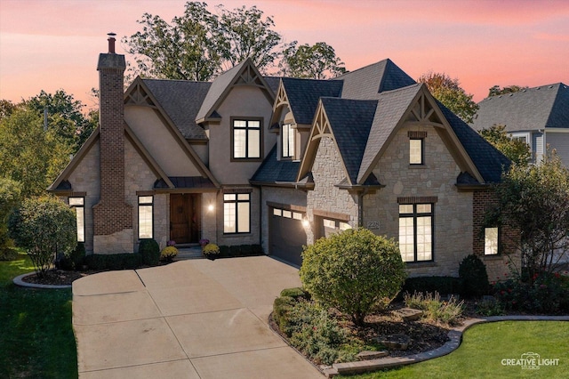 view of front facade featuring a chimney, stucco siding, concrete driveway, a garage, and stone siding