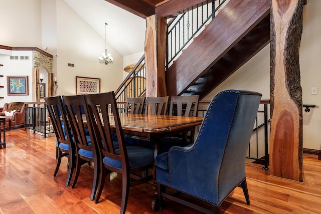 dining room with a chandelier, visible vents, and wood finished floors