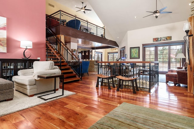 living room featuring ceiling fan, plenty of natural light, wood finished floors, and visible vents