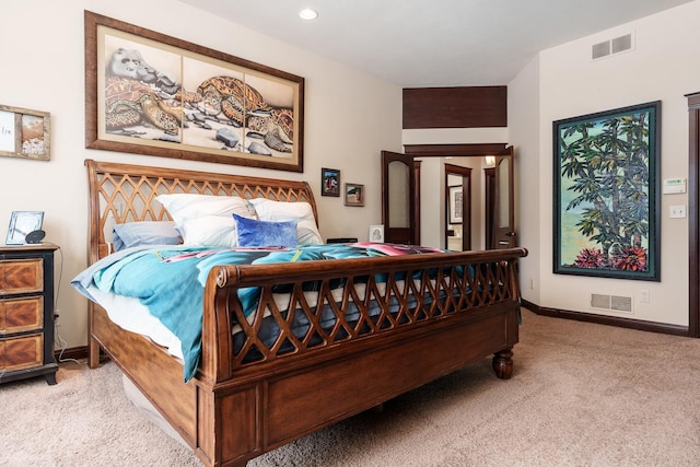 bedroom with baseboards, visible vents, and light colored carpet